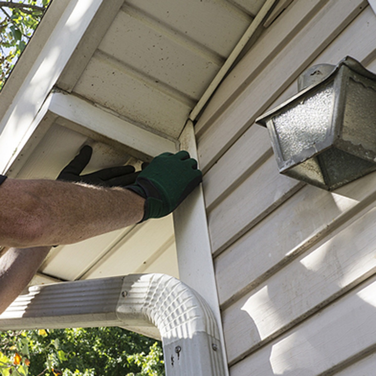 Inspecting damaged vinyl sidings fro homes in Hamburg, NY